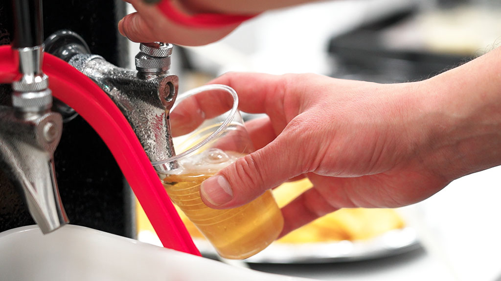 Staff pouring beer from the tap at a venue